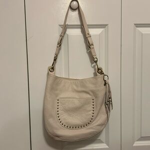 The Sak -- Leather antique white colored hobo bag w/brass tone hardware